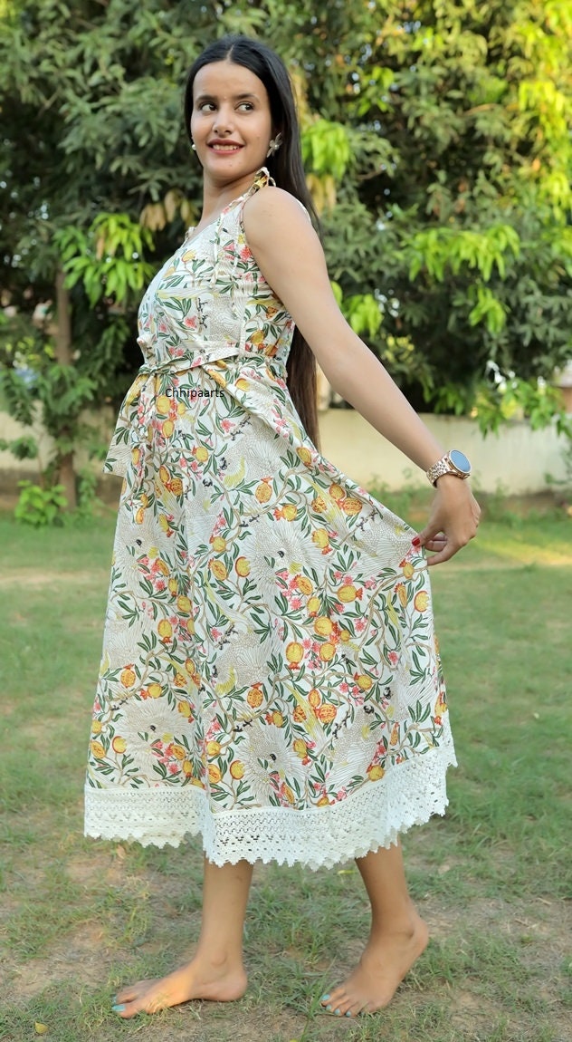 Smocked Bodice, Edged With a Ruffle and Has Adjustable Tie