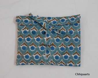 May include: A blue and brown fabric bag with a floral pattern. The bag has a drawstring closure and is folded in half. The text "Chhipaarts" is visible on the bag.