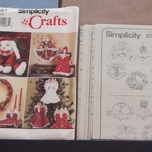 May include: Two Simplicity sewing patterns for crafts. The first pattern is for a bunny, a wreath, and a Christmas tree topper. The second pattern is for a variety of Christmas ornaments. Both patterns are labelled "Simplicity Crafts".