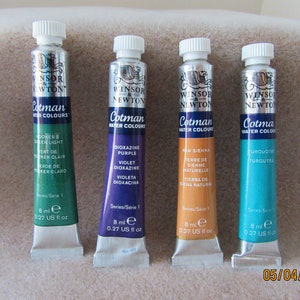 May include: Four tubes of Winsor & Newton Cotman watercolours. The tubes are labelled with the colour names: Hooker's Green Light, Dioxazine Purple, Raw Sienna, and Turquoise. Each tube contains 8 ml (0.27 UK fl oz) of paint.