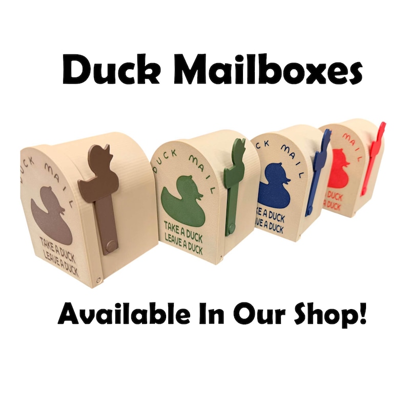 May include: A row of beige duck-themed mailboxes with different colored duck cutouts and handles. Each mailbox has the words "Duck Mail" and "Take a Duck, Leave a Duck" printed on it. The text "Duck Mailboxes" and "Available In Our Shop!" are also visible.