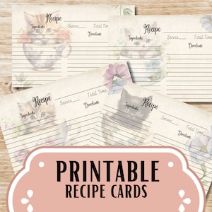 May include: Printable recipe cards with a vintage aesthetic. Each card features a watercolor illustration of a kitten in a teacup, surrounded by floral accents. The cards have lines for ingredients, servings, time, and directions. The text "PRINTABLE RECIPE CARDS" is displayed.