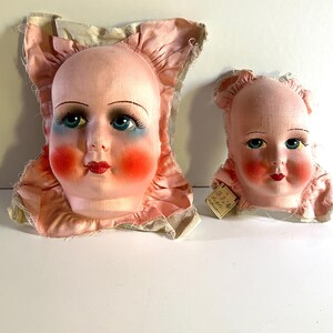 Dos viejas cabezas de muñecas de tela Boudoir nunca utilizadas, década de 1900