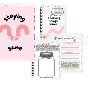May include: A pink and white notebook with the text "staying sane" on the cover. The notebook has a spiral binding and is open to a page with the title "Tracking things down". The page also includes a section for "Mental Health Goals" with space for writing down goals and a jar for storing notes.