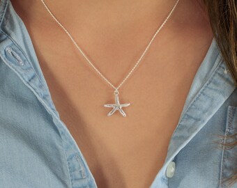 May include: A silver necklace with a delicate starfish pendant.