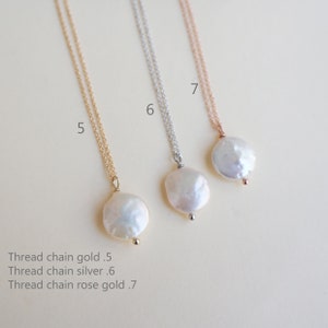 May include: Three delicate necklaces with pearl pendants. The necklaces are available in gold, silver, and rose gold. The pearl pendants are all the same size and shape, and they have a slightly irregular, natural look.