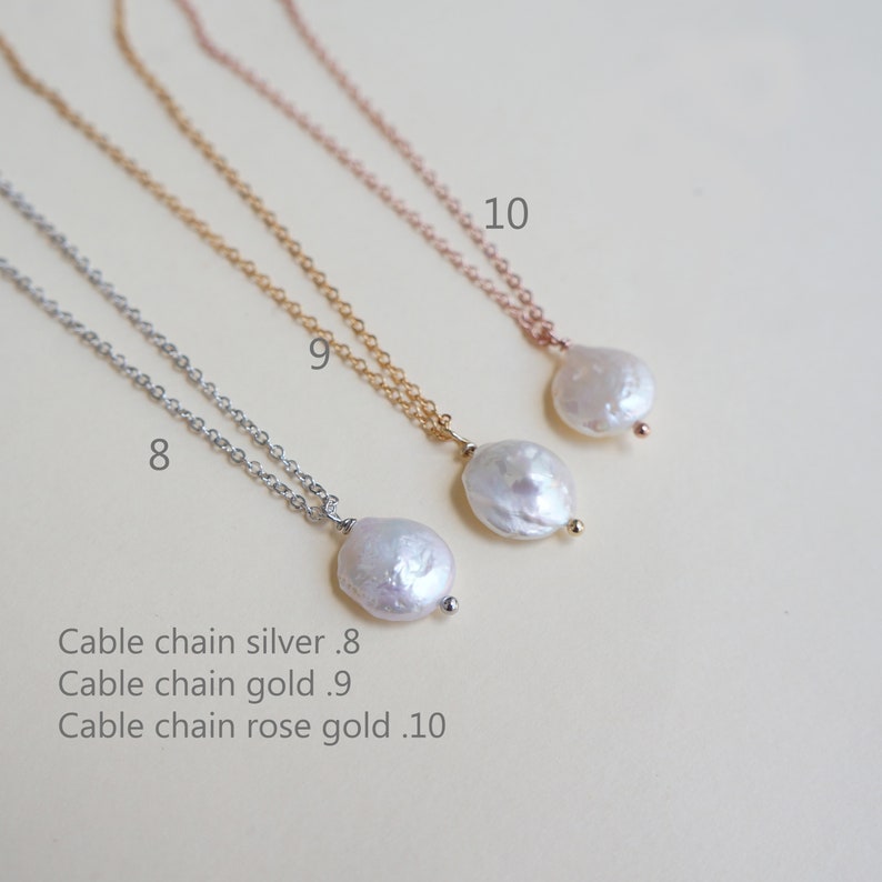 May include: Three delicate necklaces with pearl pendants. The necklaces are silver, gold, and rose gold. The pearls are white and have an irregular shape. The necklaces are labeled 8, 9, and 10.