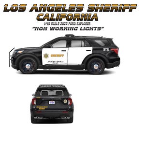 May include: A black and white Los Angeles Sheriff Ford Explorer model car. The text on the car reads "LOS ANGELES SHERIFF CALIFORNIA" and "NON WORKING LIGHTS". The model is 1/45 scale.