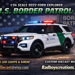 May include: A white 1/24 scale 2022 Ford Explorer model with U.S. Border Patrol markings. The model features working LED lights and siren. The vehicle has a green stripe and the text "U.S. Border Patrol".