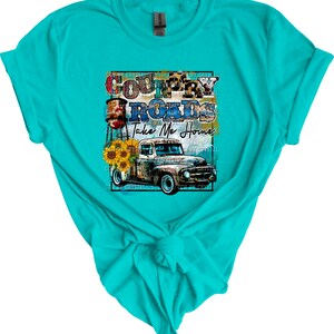 May include: A turquoise t-shirt with a graphic design of a vintage truck, water tower, sunflowers, and the text "Country Roads Take Me Home".
