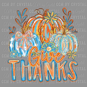 May include: A digital illustration featuring three pumpkins in shades of blue and orange, adorned with floral accents and the words "Give Thanks." The pumpkins have a textured appearance, with gold glitter accents. The overall design is set against a gray background.