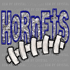 May include: A silver glitter design of the word "Hornets" with a blue outline. The word is above a white and black illustration of a football.