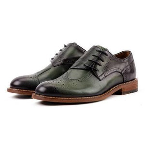 May include: A pair of green leather brogue shoes with a black leather toe cap and a brown leather sole.