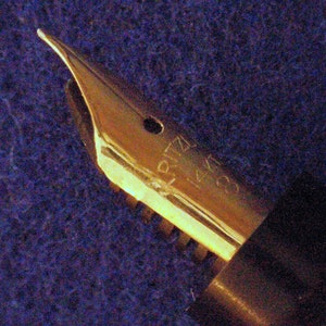 May include: Gold-toned fountain pen nib with the inscription "RITZ 14K 585" on the side.