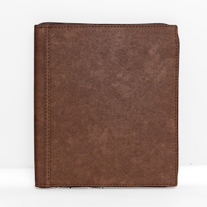 May include: A rectangular brown portfolio case with a textured finish and a vertical stitched seam along the left side. The case features a dark brown zipper closure that runs along the right edge and top, providing a secure enclosure for contents.