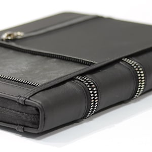 May include: A white ceramic mug with a black handle and the text "But First, Coffee" in a handwritten style. The mug is on a white surface. The mug is 10 cm tall.