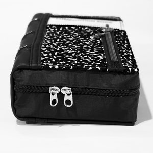 May include: Black zippered pouch with a notebook paper design. The pouch has two zipper closures and a black fabric lining.