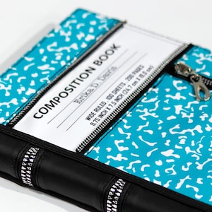 May include: A composition book cover featuring a bright turquoise and white speckled pattern with a black spine and black zipper accents. The white label reads COMPOSITION BOOK, Erika D. Davis, WIDE RULED, 100 SHEETS, 200 PAGES, 9.75 INCH X 7.5 INCH.