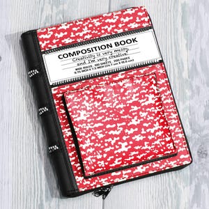 May include: A red and white camouflage patterned composition book cover with a black spine featuring zipper accents. The label reads: COMPOSITION BOOK, Creativity is very messy, and I'm very creative, WIDE RULED, 100 SHEETS, 200 PAGES, 9.75 INCH X 7.5 INCH.