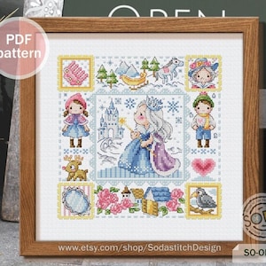 May include: A cross-stitch pattern featuring a winter scene with a princess, a castle, a reindeer, a bird, and other details. The pattern is in a square frame with a white background and colorful details. The text "SO-OP3228" is in the lower right corner of the image.