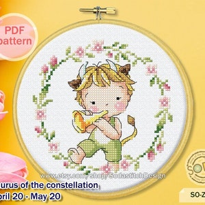 May include: A cross-stitch pattern featuring a cartoon illustration of a Taurus zodiac sign. The illustration depicts a young person with a bull's horns, holding a trumpet, surrounded by a wreath of pink flowers. The text "Taurus of the constellation April 20 - May 20" is displayed below the illustration.
