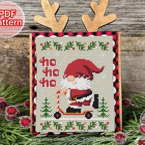 May include: Cross stitch pattern featuring a gnome riding a scooter with the words "Ho Ho Ho" and a red and black buffalo plaid background.