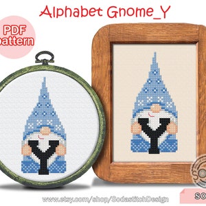 May include: A blue and white gnome holding the letter Y. The gnome is wearing a blue hat with white snowflakes. The gnome is holding the letter Y in front of its body. The image is a cross stitch pattern.