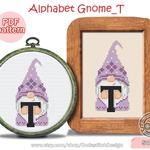 May include: A purple gnome holding the letter T in a wooden frame. The gnome has a white beard and a purple hat with white flowers. The frame has the text "Alphabet Gnome_T" and "SO-T" at the bottom.