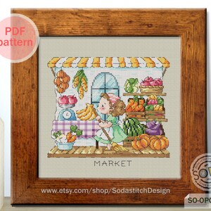 May include: A cross-stitch pattern of a girl in a green dress standing in front of a market stall with a variety of fruits and vegetables. The stall has a sign that says "MARKET".