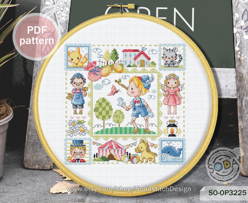 May include: A colorful cross-stitch pattern featuring a whimsical scene with children, animals, and a circus tent. The pattern is framed in a wooden hoop and includes the text "SO-OP3225" and "www.etsy.com/shop/SodastitchDesign".