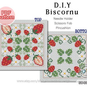May include: A DIY Biscornu PDF pattern featuring cross-stitch designs of strawberries, leaves, and white flowers. The top and bottom views are displayed, with text indicating it can be used as a needle holder, scissors fob, or pincushion.