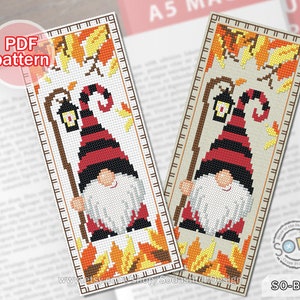 May include: A cross stitch pattern for a bookmark featuring a gnome with a red and black striped hat holding a lantern. The gnome is standing in front of a background of autumn leaves in shades of orange, yellow, and red.