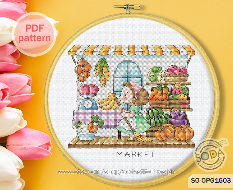 May include: A cross-stitch pattern of a girl shopping at a market. The market has a striped awning and is filled with colorful fruits and vegetables. The girl is holding a broom and wearing a green dress. The text "MARKET" is below the market.