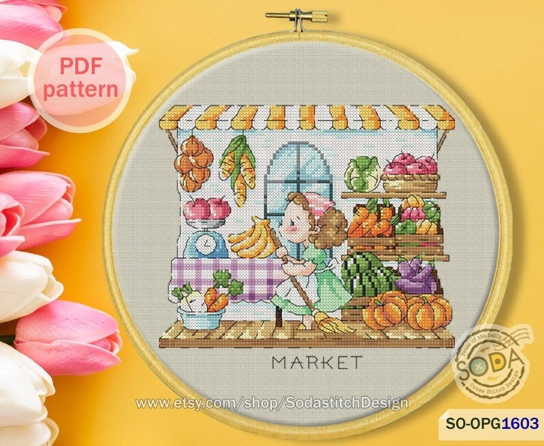 May include: Cross stitch pattern of a colorful market scene with a girl sweeping the floor. The market has a striped awning and is filled with fruits, vegetables, and other goods. The text "MARKET" is displayed below the scene.