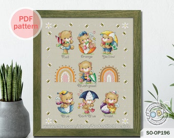 May include: Cross stitch pattern featuring a rainbow and seven bears wearing hats and holding umbrellas, each bear representing a different color: red, orange, yellow, bluish green, blue, dark blue, and violet. The pattern includes the text "SODA" and "SO-OP196".