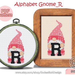 May include: Cross-stitch patterns of a gnome holding the letter "R" in a black font. The gnome wears a pink hat with white polka dots and a white beard. One is framed in a wooden hoop, the other in a wooden frame. Text reads "Alphabet Gnome_R".