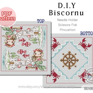 May include: A PDF pattern for a DIY biscornu, a small, square, double-sided, stuffed cushion. The top side features a mermaid with a castle and fish. The bottom side features a nautical wheel with crabs.