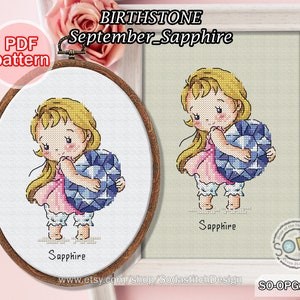 May include: Cross stitch pattern PDF for a September birthstone, a sapphire. The pattern features a cartoon girl holding a large blue sapphire gemstone. The text "September_Sapphire" and "Sapphire" are included in the image.