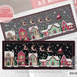 May include: Two cross stitch bookmark patterns featuring a winter village scene with houses, snow, and reindeer. The top pattern is on a gray background, and the bottom pattern is on a black background. The text "SO-BM66" is in the bottom right corner of the image.