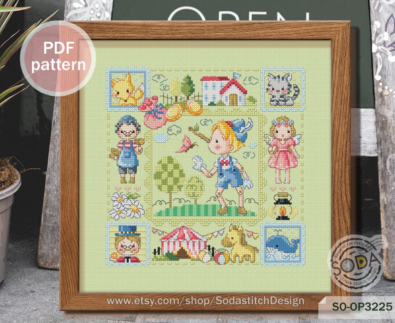 May include: A colorful cross-stitch pattern featuring a whimsical scene with children, animals, and a circus tent. The pattern is framed in a wooden frame and includes the text "SO-OP3225" and "www.etsy.com/shop/SodastitchDesign".