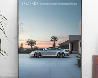 May include: A silver Porsche 997 GT3 sports car parked in front of a modern house with a sunset in the background. The car is on a paved driveway with a palm tree in the background. The text "997 GT3" is at the top of the image.