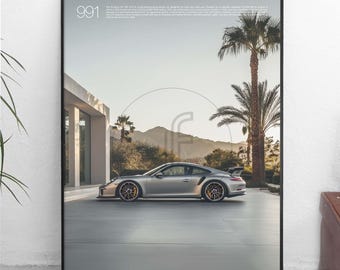 May include: A black and white poster with the number 991 printed in white at the top. The poster features a silver Porsche 911 GT3 RS parked in a driveway with palm trees in the background. The text "Designed by Javi Pastor" is printed in the bottom left corner.