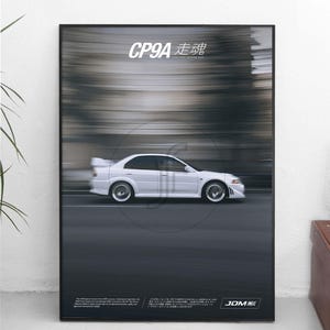May include: A framed rectangular poster featuring a white sedan in motion on a dark road. The text CP9A and Japanese characters appear at the top, with additional small text and the letters JDM at the bottom against a blurred background.