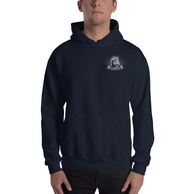 May include: A navy blue hooded sweatshirt with a white graphic of a welder on the left chest. The graphic includes the word "Welder" in a banner.
