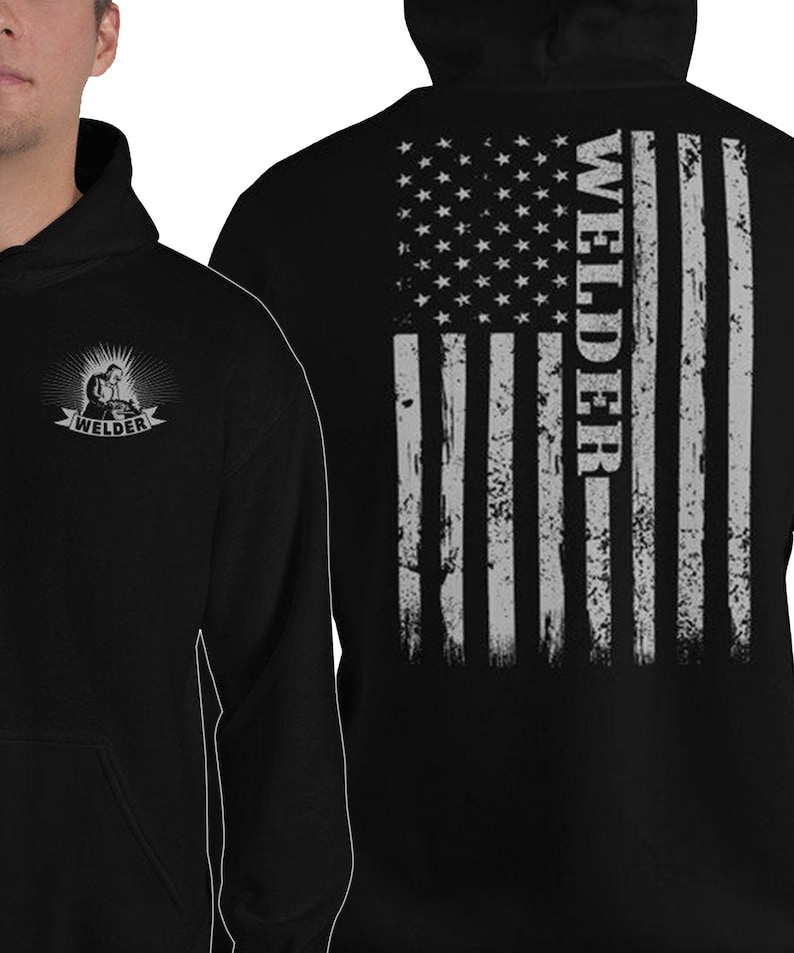 May include: Black hooded sweatshirt with a distressed American flag design on the back and a small welder graphic on the front. The flag is gray and white and the text "Welder" is written vertically on the right side of the flag.