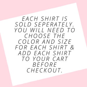 May include: White text on a white, angled background against a pink backdrop. The text reads: "EACH SHIRT IS SOLD SEPERATELY. YOU WILL NEED TO CHOOSE THE COLOR AND SIZE FOR EACH SHIRT & ADD EACH SHIRT TO YOUR CART BEFORE CHECKOUT."