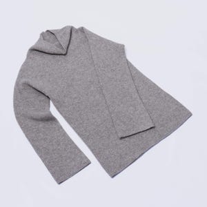 May include: A gray ribbed knit sweater with a cowl neck.