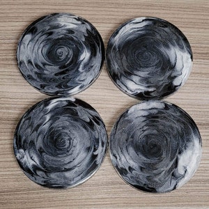 Black and white resin  coasters with a sparkly bottom. beautiful, unique design that will complement any décor style.