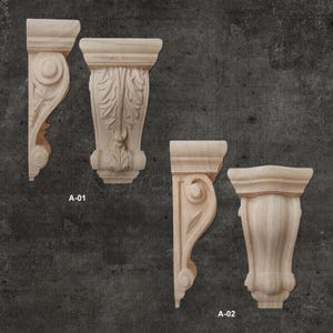 May include: Four wooden corbels with intricate carvings. Two corbels feature a leaf design, one has a scroll design, and the other has a simple, rounded design. The corbels are labeled A-01 and A-02.