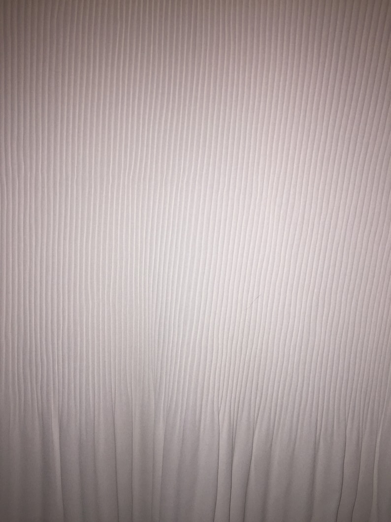 May include: White fabric with a vertical ribbed texture. The fabric has a subtle sheen and a smooth, soft feel.